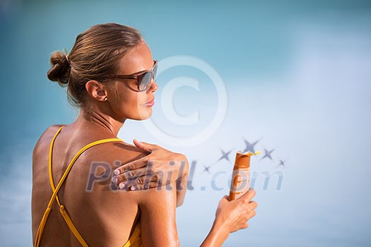 Suncream Concept. Pretty, young woman in a swimsuit is applying sunscreen trying to protect the skin from the harmful effects of sunlight she loves Suncream Concept. Pretty, young woman in a swimsuit is applying sunscreen trying to protect the skin from the harmful effects of sunlight she loves