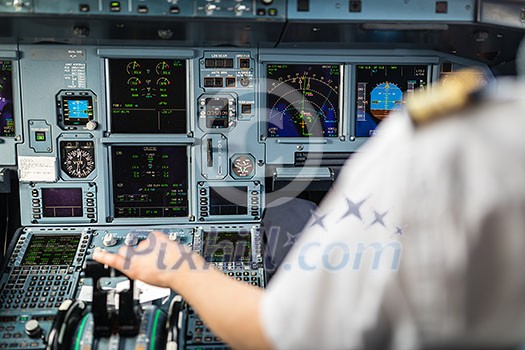 Pilot's hand accelerating on the throttle in a commercial airliner airplane flight cockpit during takeoff Pilot's hand accelerating on the throttle in a commercial airliner airplane flight cockpit during takeoff