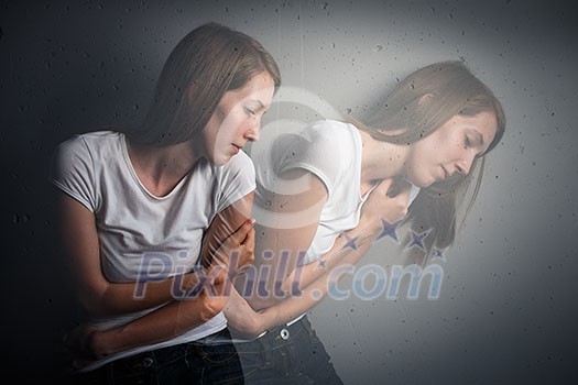 Young woman suffering from a severe depression/anxiety (color toned image; double exposure technique is used to convey the mood of unease, progression of the anxiety/depression) Young woman suffering from a severe depression/anxiety (color toned image; double exposure technique is used to convey the mood of unease, progression of the anxiety/depression)