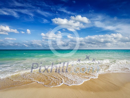 Beach holidays vacation background - beautiful beach and waves of Caribbean Sea