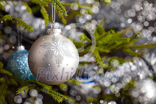 Christmas celebration holiday background - christmas-tree decoration bauble on decorated Christmas tree with defocused blurred lights bokeh and copyspalce