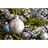 Christmas celebration holiday background - christmas-tree decoration bauble on decorated Christmas tree with defocused blurred lights bokeh and copyspalce