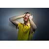 Young man suffering from an intense headache/migraine/anxiety attack - color toned image