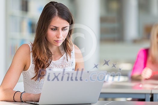Pretty young college student in a library (shallow DOF; color toned image) Pretty young college student in a library (shallow DOF; color toned image)