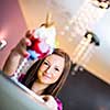 Cute young woman in an ice cream parlor, taking her ice-cream from the counter