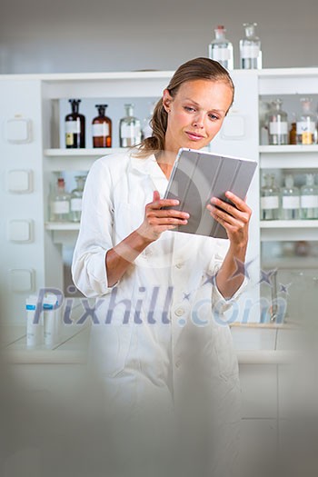 Portrait of a female researcher doing research in a lab, using a tablet computer for data collection and visualization(shallow DOF; color toned image) Portrait of a female researcher doing research in a lab, using a tablet computer for data collection and visualization(shallow DOF; color toned image)
