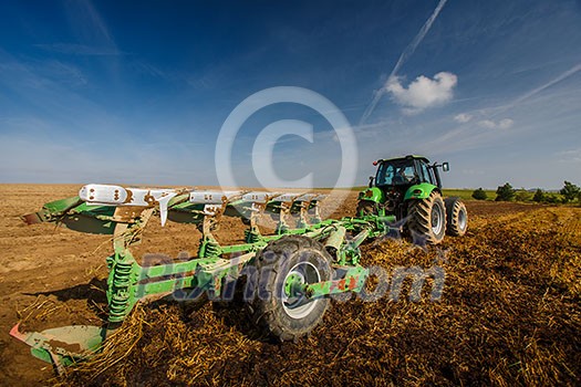 Tractor working on the farm, modern agricultural transport, farmer working in the field, tractor on a sunset background, cultivation of land, agricultural machine Tractor working on the farm, modern agricultural transport, farmer working in the field, tractor on a sunset background, cultivation of land, agricultural machine