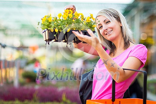 Young woman buying flowers at a garden center Young woman buying flowers at a garden center