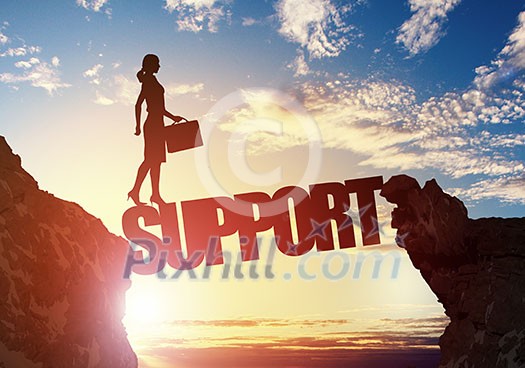Businesswoman running on credit word bridge over precipice Businesswoman running on credit word bridge over precipice