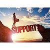 Businesswoman running on credit word bridge over precipice