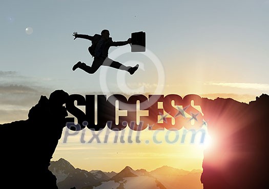 Businessman running on success word bridge over precipice Businessman running on success word bridge over precipice