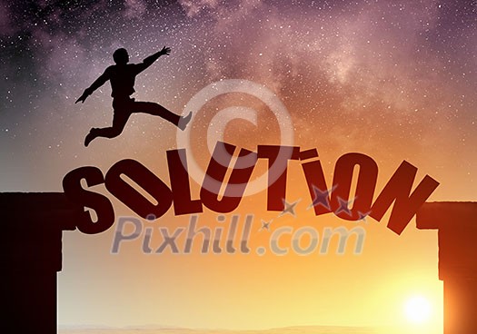Businessman running on solution word bridge over precipice Businessman running on solution word bridge over precipice