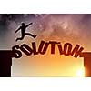 Businessman running on solution word bridge over precipice