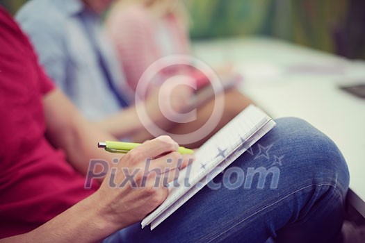 male student taking notes in classroom. business education concept, casual young businessman on seminar training male student taking notes in classroom. business education concept, casual young businessman on seminar training