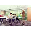group of students study with professor in modern school classroom