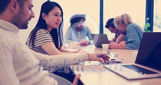 Group of a young business people discussing business plan at modern startup office building Group of a young business people discussing business plan at modern startup office building