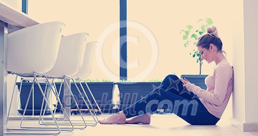 beautiful young women using tablet computer on the floor of her luxury home beautiful young women using tablet computer on the floor of her luxury home