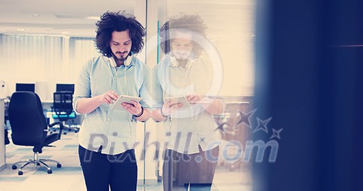 young casual businessman using tablet computer in startup office young casual businessman using tablet computer in startup office