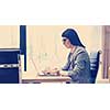 Young female Entrepreneur Freelancer Working Using A Laptop In Coworking space