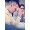 A time for relax. Young tired casual businessman relaxing at the desk in his office