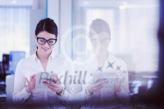 Pretty Businesswoman Using Tablet In front of startup Office Interior Pretty Businesswoman Using Tablet In front of startup Office Interior