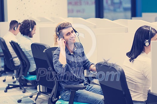 group of young business people with headset working and giving support to customers in a call center office group of young business people with headset working and giving support to customers in a call center office