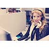 young smiling female call centre operator doing her job with a headset