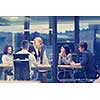 Group of a young business people discussing business plan at modern startup office building