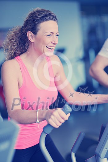 sport, fitness, lifestyle, technology and people concept - smiling woman exercising on treadmill in gym sport, fitness, lifestyle, technology and people concept - smiling woman exercising on treadmill in gym
