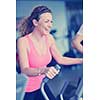 sport, fitness, lifestyle, technology and people concept - smiling woman exercising on treadmill in gym