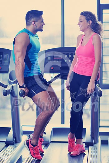 attractive couple at the gym looking happy attractive couple at the gym looking happy