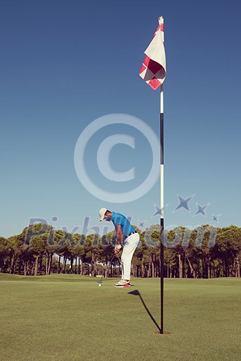 golf player hitting shot with driver on course at beautiful sunny day golf player hitting shot with driver on course at beautiful sunny day