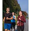 group of young people jogging on country road runners running on open road on a summer day