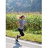 young woman enjoying in a healthy lifestyle while jogging along a country road, exercise and fitness concept