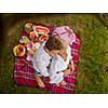 Couple in love enjoying picnic time drink and food in beautiful nature on the river bank top view
