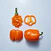 Food styling image design of yellow bell pepper slices on gray background. Healthy eating diet food concept top view