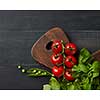 Fresh vegetables and herbs on a dark wooden background. Space for text and flat lay. Vegan concept