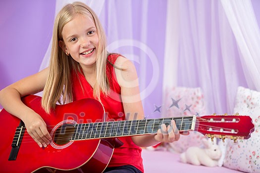 Teenage girl with her guitar in her lovely room Teenage girl with her guitar in her lovely room