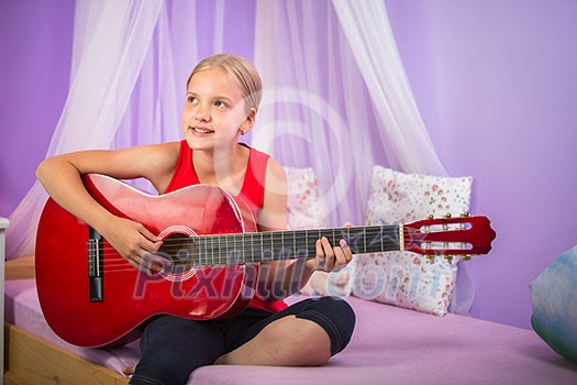 Teenage girl with her guitar in her lovely room Teenage girl with her guitar in her lovely room