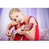 Teenage girl with her guitar in her lovely room