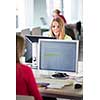Pretty, female student looking at a desktop computer screen, learning unpleasant news about her exam results. University/office/school concept