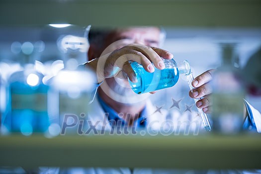 Senior male researcher carrying out scientific research in a lab (shallow DOF; color toned image) Senior male researcher carrying out scientific research in a lab (shallow DOF; color toned image)
