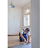 DIY, repair, building and home concept - close up of male hands lying parquet floor board/laminate flooring (shallow DOF; color toned image)
