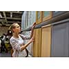 Pretty, young woman choosing the right furniture for her apartment in a modern home furnishings store (color toned image; shallow DOF)