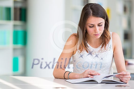 Pretty young college student in a library (shallow DOF; color toned image) Pretty young college student in a library (shallow DOF; color toned image)