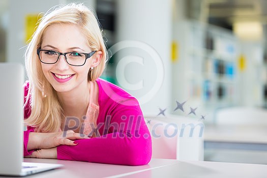 Pretty young college student in a library (shallow DOF; color toned image) Pretty young college student in a library (shallow DOF; color toned image)