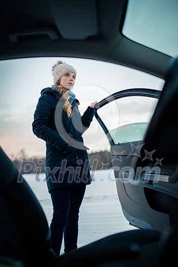 Woman driving a car - female driver at a wheel of a modern car, looking happy, smiling with a relaxed smile (shallow DOF; color toned image) Woman driving a car - female driver at a wheel of a modern car, looking happy, smiling with a relaxed smile (shallow DOF; color toned image)