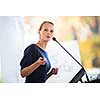 Pretty, young business woman giving a presentation in a conference/meeting setting (shallow DOF; color toned image)