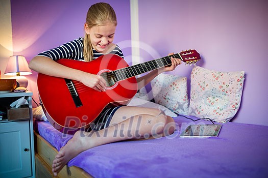 Teenage girl with her guitar in her lovely room Teenage girl with her guitar in her lovely room