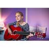 Teenage girl with her guitar in her lovely room